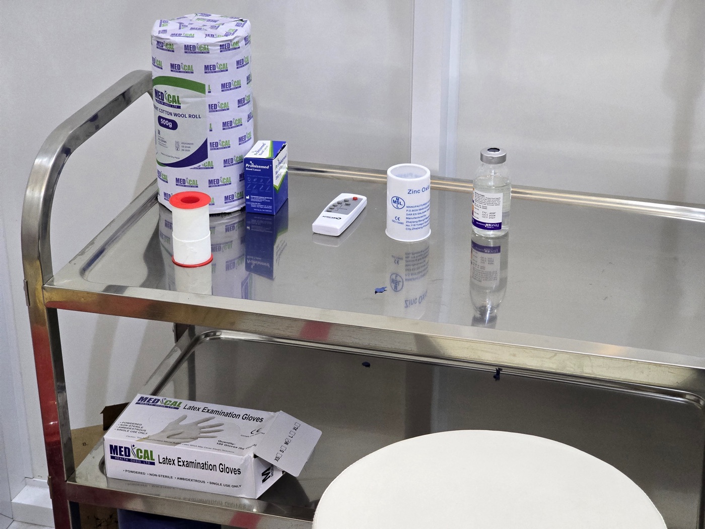A dressing trolley at MacWish Medical Centre, stocked with cotton wool, plaster and examination gloves